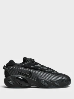 Nocta Glide Sneakers i Black, Black, Iron Grey og University Gold